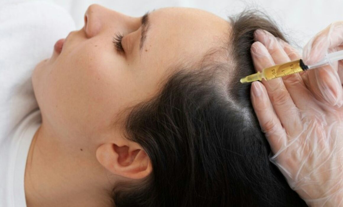 Patient receiving a non-surgical hair restoration consultation at a medical aesthetics clinic in Edmond Oklahoma.
